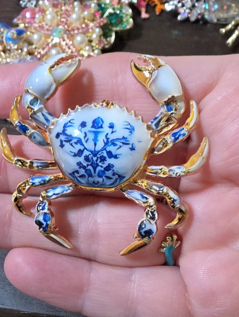 A116- Gold and White Porcelain Blue Floral Crab Brooch